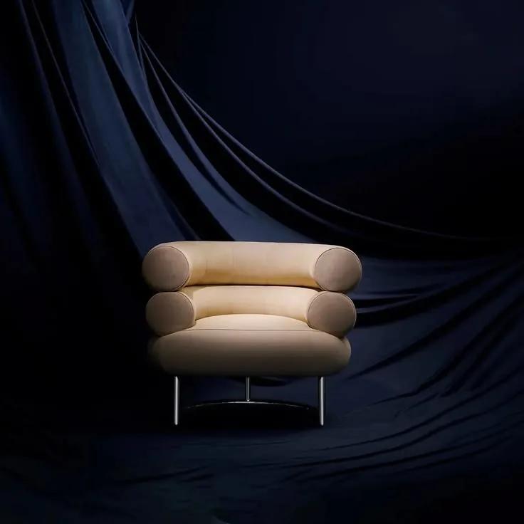 A cream three-seater against a navy drape