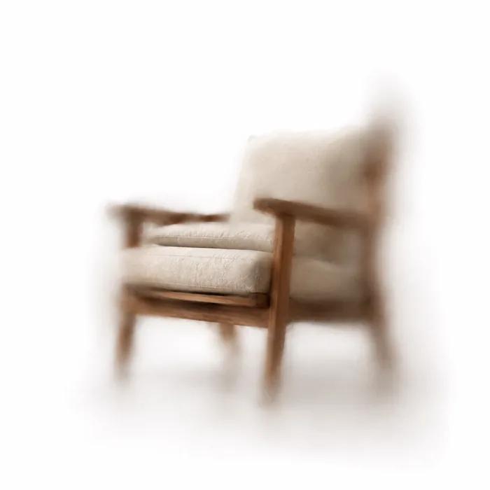 A wooden-framed armchair on a plain ground